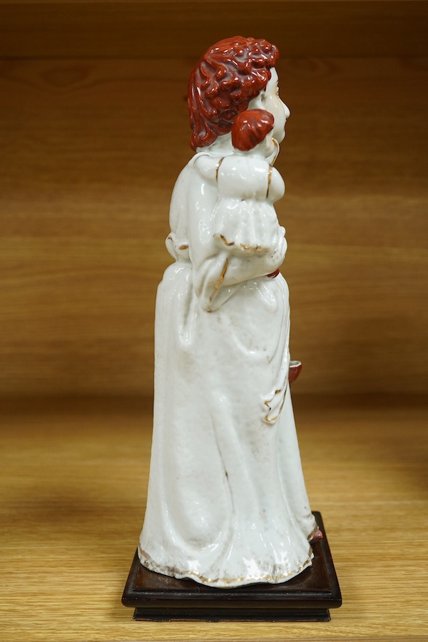 A Chinese porcelain group, mother and child on stand, Republic period, 29cm high. Condition - the collar of the garment and contents of basket both broken.